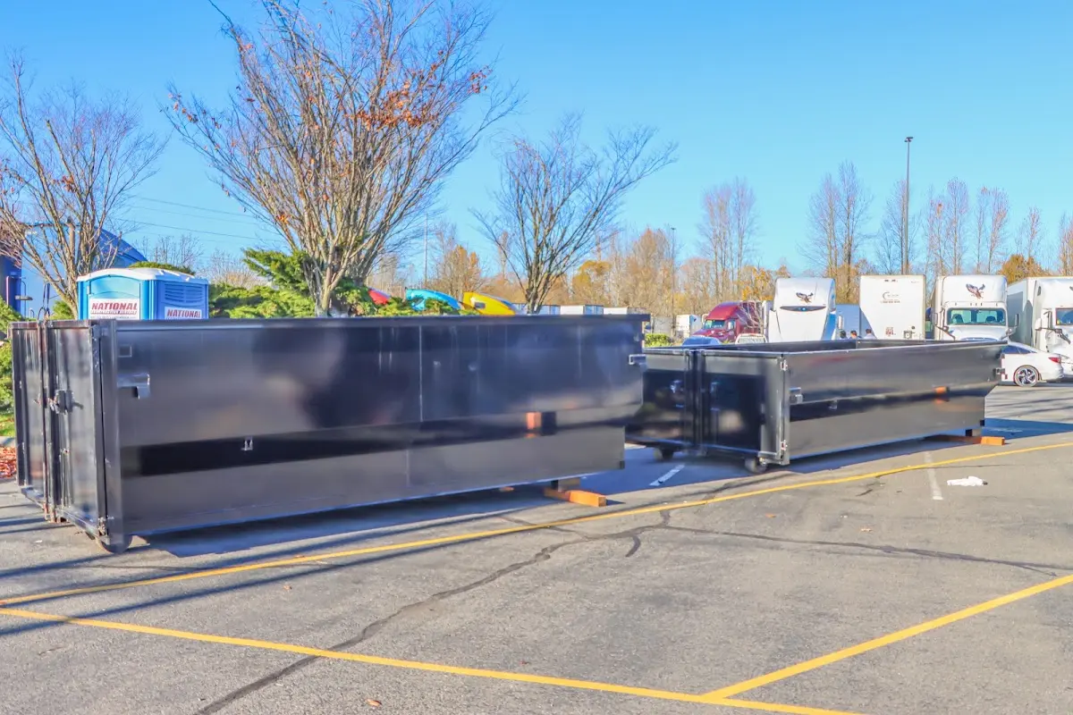Professional dumpster rental service with roll-off container on residential driveway in Shillington
